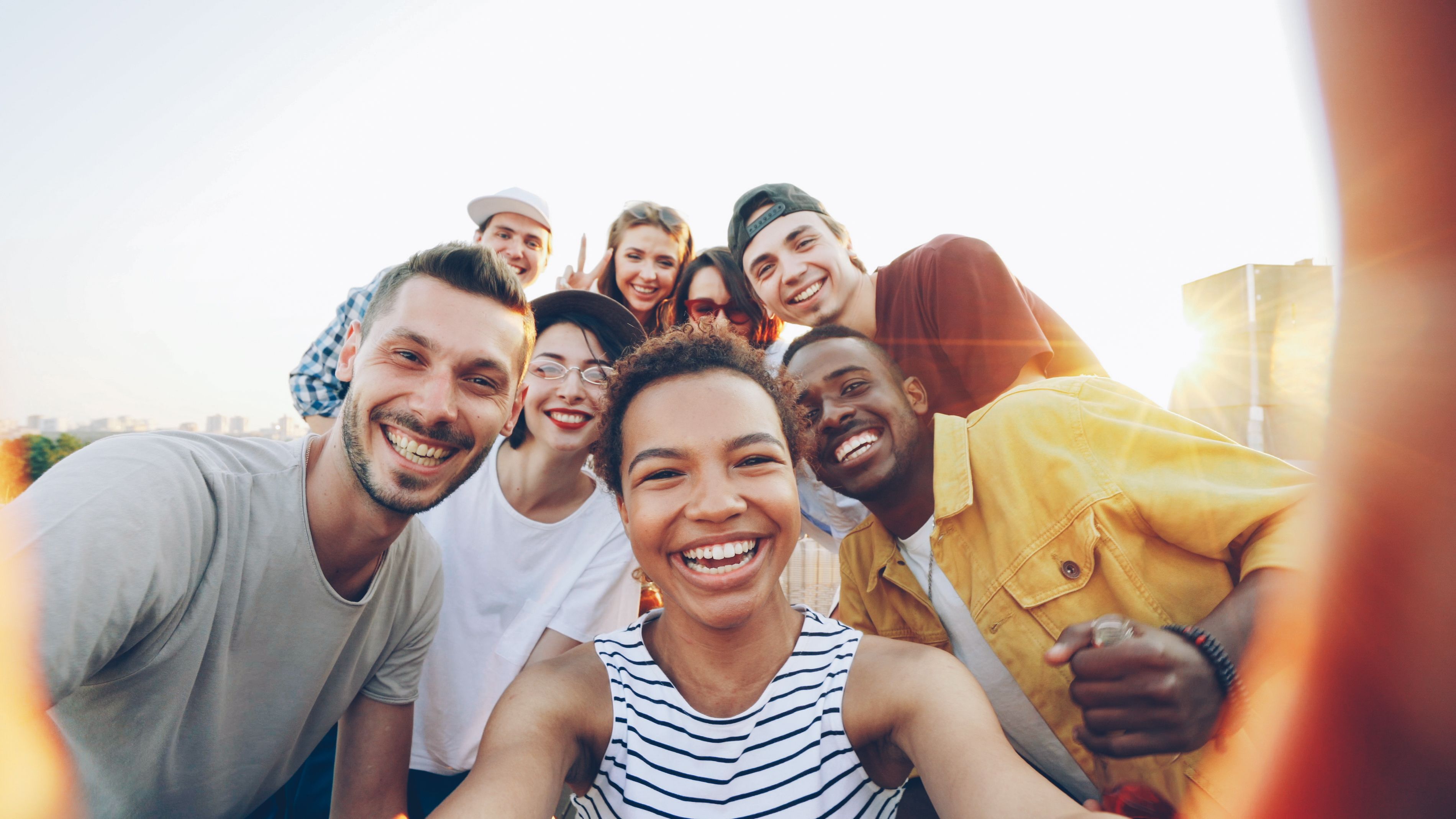 A group of people smiling together outdoors